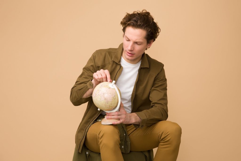 sitting man holding a globe