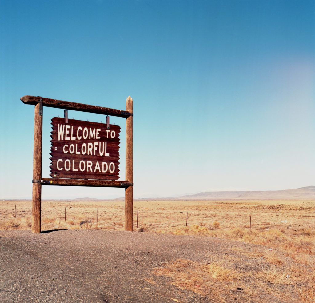 wooden welcome sign of Colorado