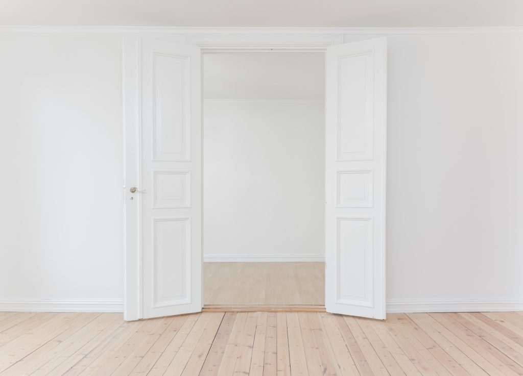 open white door of an empty room