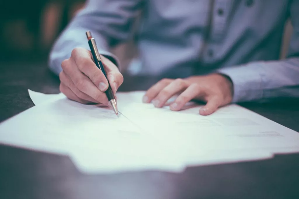 person signing a document