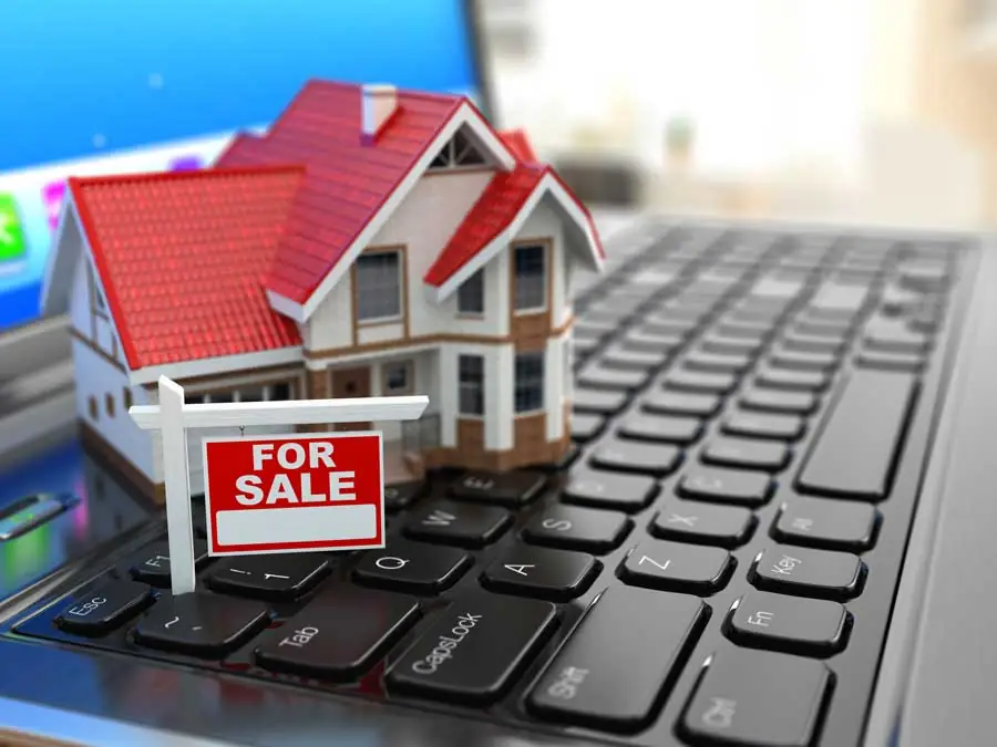 mini house model with for sale sign
