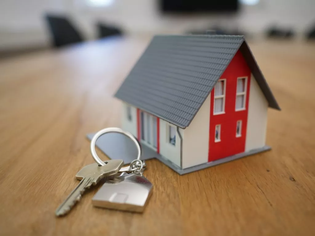 miniature house with a big key