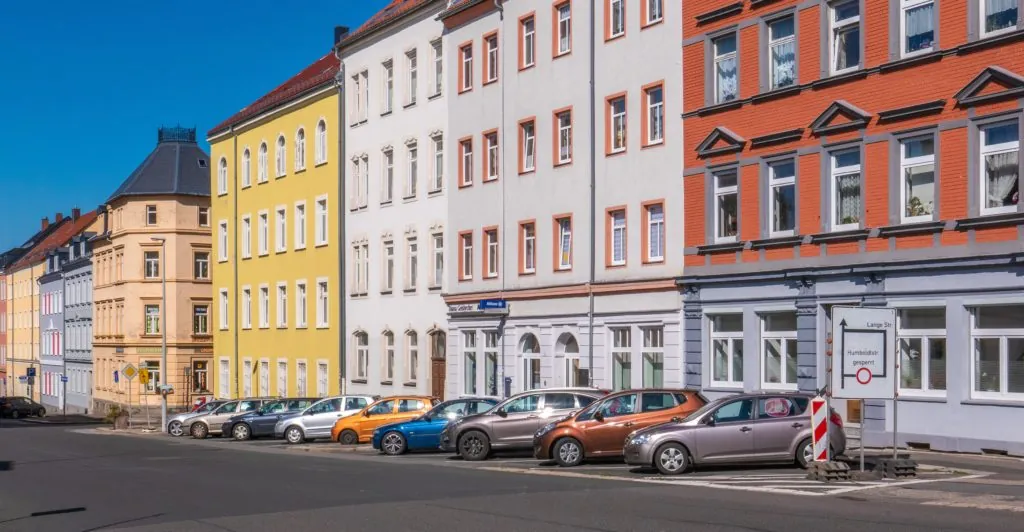 rows of condominium buildings with parked cars